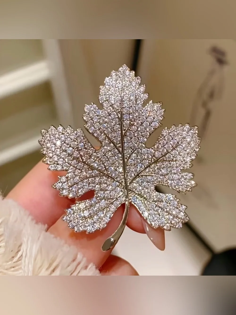 Sparkling silver-tone maple leaf brooches featuring pavé-set clear rhinestones.